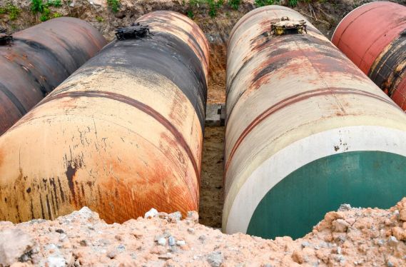 Multiple underground storage tanks exposed in an excavation
